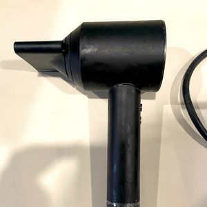 Dyson Hair Dryer. Works perfectly. One attachment Dries hair fast and smoothly.
